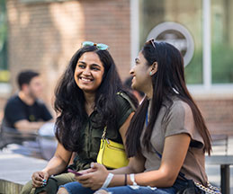 Photo of students chatting with each other. Link to Gifts of Life Insurance.